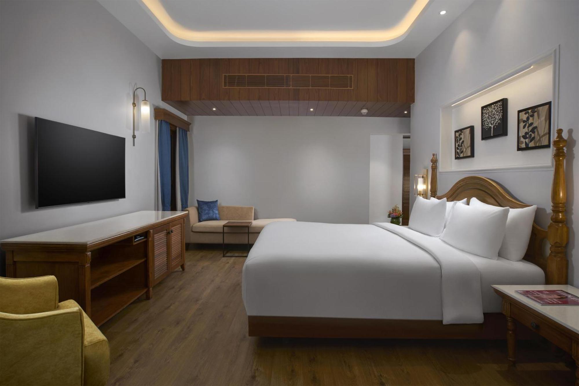 Radisson Suite Balcony Bathtub Living room & Garden view of Food & Beverages SPA 1 Goan Bottle INR 500 Hotel Credit spend of INR 5000 Early Check upto 2 hours subject